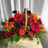 A basket filled with such fall beauties; such as orange spray roses