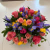 A lively and vibrant floral arrangement that bursts with color and energy.