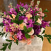 An eye-catching, luxurious arrangement featuring vibrant magenta orchids, rich plum dahlias, and
