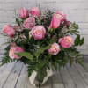 A dozen pink roses are a classic romantic gift. They will be