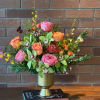 A stunning symphony of seasonal blooms featuring lush pink garden roses, vibrant
