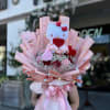 A wrapped bouquet of flowers is a beautifully arranged collection of blooms