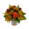 This is a lovely, compact floral arrangement with warm, autumnal theme. It