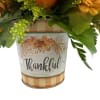 This is a lovely, compact floral arrangement with warm, autumnal theme. It