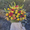 Seasonal blooms in autumn colors make a lovely display for the service.