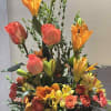 This arrangement contains varity of orange flowers. Orange lilies, Orange roses, Orange