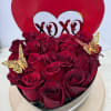 A dozen and a half red roses in a heart shaped box