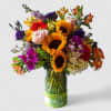 Lovely roses orchids and more arranged tall in a modern glass cylinder
