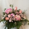 Lovely combination of pink lilies, carnations, roses, and stock with greens in