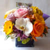 Roses orchids and more arranged in a black modern glass cube style