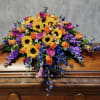 Multi color casket spray to make a lovely addition to your casket.