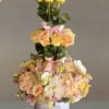 Where every bloom wears a crown
A stunning three-tier arrangement of peach roses