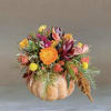 A beautiful multi-colored flower arrangement on a authentic pumpkin. Perfect for time