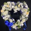 A heart shaped wreath ring covered in mixed flowers of your color