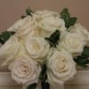 A dozen playa blance roses, tussie mussie style 
In a sleek vase