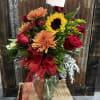 The perfect bouquet of Fall colored flowers arranged in a vase 