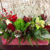 Our locally crafted red wooden crate is filled with fresh, assorted evergreens