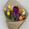 Bouquet of mix tulips wrapped in burlap with fillers (no vase).