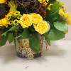 a galvanized short cylinder filled with a modern take on autumn