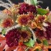 An arrangement that feels like a cozy fall day with fall leaves