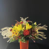 An arrangement that feels like a cozy fall day with fall leaves