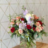 A lush mix of blooms and fresh greenery, artfully arranged to capture