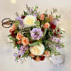 A lush mix of blooms and fresh greenery, artfully arranged to capture