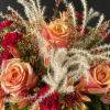 A fall inspired arrangement with roses, mini carnations, cushion sprays, solidago and