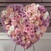 This full-heart arrangement represents unwavering devotion and respect. A solid bloom of