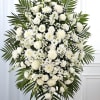 This easel spray stands as a quiet tribute to a life well-lived.