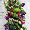 This easel spray stands as a quiet tribute to a life well-lived.