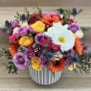 A mix of beautiful flowers with vase included. 