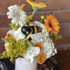 This cheerful arrangement captures the essence of a thriving garden with its
