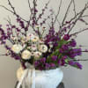 This stunning arrangement features an abundance ranunculus, tulips and bloomed stems, elegantly