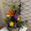 Planter filled with English Ivy, Calathea, Lady Palm,and seasonal flowers