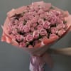 A stunning symphony of soft pink spray roses, delicately wrapped in blush-toned
