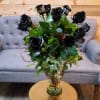 A striking arrangement of velvety black roses, their petals tinted to perfection