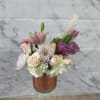 A chic cylinder with a pink wrap in the vase blooming with