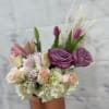 A chic cylinder with a pink wrap in the vase blooming with