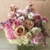 A violet, pale pink pastel arrangement with the finest colors and flowers.