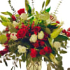 A stunning holiday bouquet featuring vibrant red and pure white roses, elegant