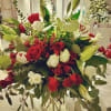 A stunning holiday bouquet featuring vibrant red and pure white roses, elegant