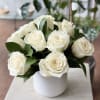 One dozen white roses in a ceramic vase, short design.