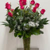A dozen roses arranged in a vase by our expert designers, dressed