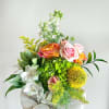Bright and cheerful, this garden-style design pairs orangey/peach roses, pink spray roses