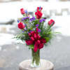 A beautiful all around vase showcasing six elegant crimson roses with six
