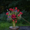 A beautiful all around vase showcasing six elegant crimson roses with six