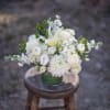 Soothing creamy and white blooms arranged in a compact fashion in a