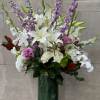 Tall and lush display of flowers features, white hydrangeas, hybrid delphinium, lavender
