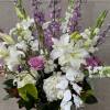 Tall and lush display of flowers features, white hydrangeas, hybrid delphinium, lavender